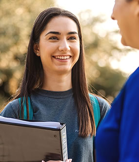 Young female smiling at the person with her